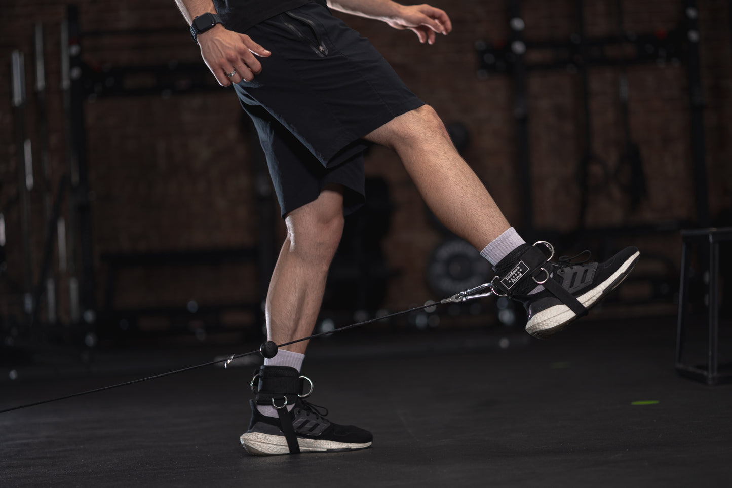 Leg raise with IronSpark Fitness ankle straps